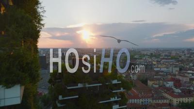 Tight Flight Around Modern Ecological Sustainable Tall Apartment Building At Sunset. Green Plant Cover Of Buildings For Better Interior Conditions. Milano, Italy. - Video Drone Footage