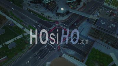 Static Shot Of Vehicles Passing Through Road Intersection. High Angle View Of Traffic In City At Dusk. Milano, Italy. - Video Drone Footage