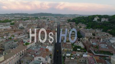 Buildings In Metropolis, Forwards Fly Above Straight Street Lined With Old Multistorey Apartment Houses With Rooftop Terraces. Rome, Italy - Video Drone Footage