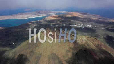 Spain, Canary Islands, Lanzarote, Guinate, Aerial View Over Volcano La Corona - Video Drone Footage