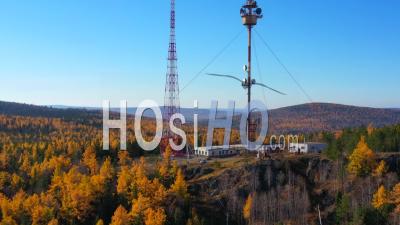 Radio Tower On Top Of Mountain In The Middle Of A Forest. View From Above - Video Drone Footage