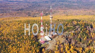 Radio Tower On Top Of Mountain In The Middle Of A Forest. View From Above - Video Drone Footage