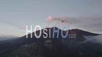 Etna Smoke Eruption Volcano At Sunset With Clouds - Video Drone Footage