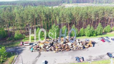 2022 -Wrecked And Burned Cars In The Car Cemetery Sitting In A Pile Many With Bullet Holes From Russian Aggression, Irpin - Video Drone Footage