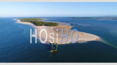 A Van Drives Off A Large Vessel And Onto Rainbow Beach In Queensland, Australia - Video Drone Footage