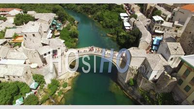 A Bird's-Eye-View Shows The Mostar Bridge And The Neretva River It Passes Over In Mostar, Bosnia - Video Drone Footage