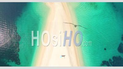 A Bird's-Eye-View Shows Tourists Swimming At Zlatni Rat Beach On Brac Island, Croatia - Video Drone Footage