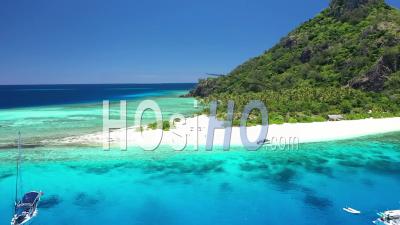 Tourists Enjoy The Beach And Boats Are Seen Anchored Near Monuriki Island, Fiji - Video Drone Footage