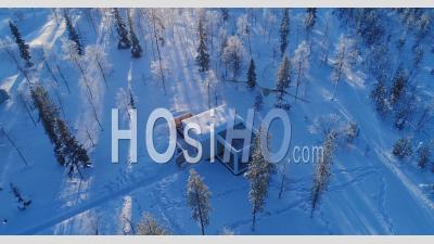 An Aerial View Shows Trees And Lodgings Of The Snow-Covered Northern Lights Ranch In Kongas, Finland - Video Drone Footage