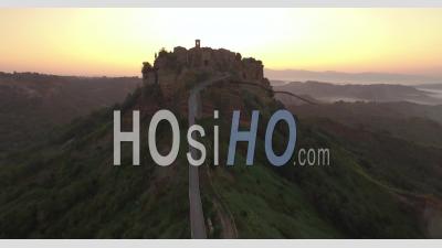 An Aerial View Shows Civita Di Bagnoregio, Italy At Sunset - Video Drone Footage