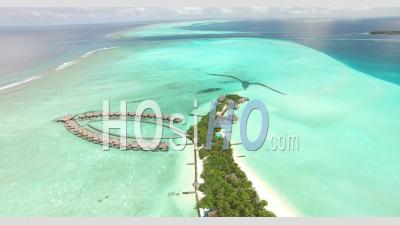 An Aerial View Shows Lodgings At An Island Resort Of Maldives - Video Drone Footage