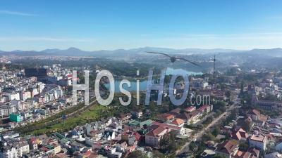 An Aerial View Shows Buildings, A Radio Tower, And A Lake Of Dalat, Vietnam - Video Drone Footage