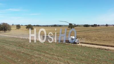2020 - A Twelve Wheeler Tows A Vehicle Behind It In The Countryside Of Parkes, New South Wales, Australia - Video Drone Footage