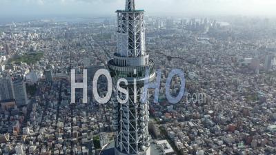 An Aerial View Highlights The Tokyo Skytree Towering Over Other Buildings In Tokyo, Japan - Video Drone Footage