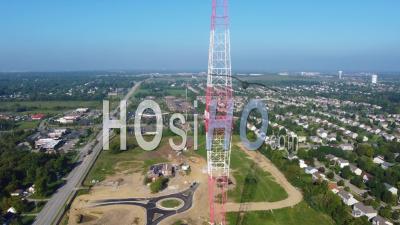 Rising Aerial Over A Huge Communications Radio Broadcast Tower Looming Over The Countryside - Video Drone Footage