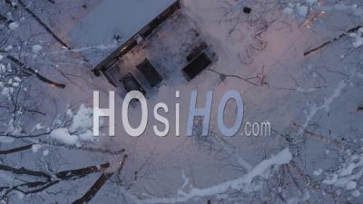 Cozy Sauna And Hot Tub In Wintery Forest, Viewed By Drone