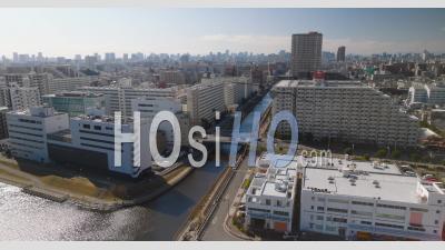 Aerial Of A River Running Through The City In Tokyo - Video Drone Footage