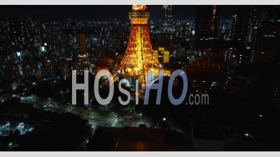 Aerial Of Tokyo Tower At Night With Cars Passing By - Video Drone Footage