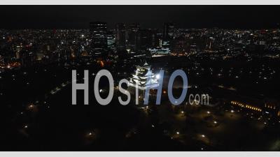 Distant Pan Of Osaka Castle At Night - Video Drone Footage