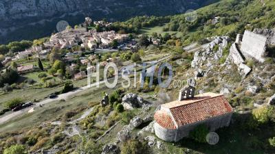 Church In The Mountain And Village Of Greolieres In The Background, Alpes Maritimes, France - Aerial Photography