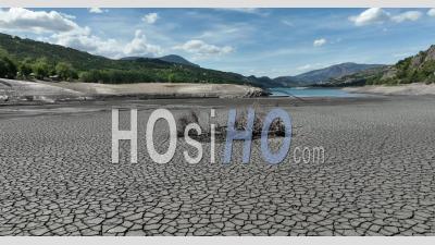 Heatwave, Dry Earth Cracked In A Period Of Drought On The Ubaye River At The Entrance Of The Serre-Poncon Lake During The 2022 Drought, Hautes-Alpes, France - Video Drone Footage