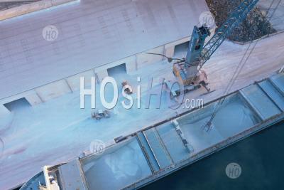 Top View Of A Cargo Ship Loading Lime In The Harbour, Martigues, Bouches-Du-Rhone, France - Aerial Photography