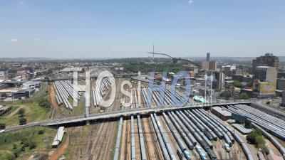 Braamfontein Train Yard And Newtown With Traffic Queen Elizabeth Bridge And Nelson Mandela Bridge, Johannesburg, South Africa - Video Drone Footage