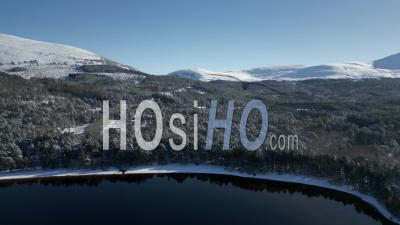 Loch Morlich And The Surrounding Area Covered In Snow, Highlands, Scotland - Video Drone Footage
