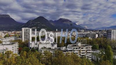Aerial View Of Grenoble And Its Buildings Under The Chartreuse Massif In The French Alps - Video Drone Footage