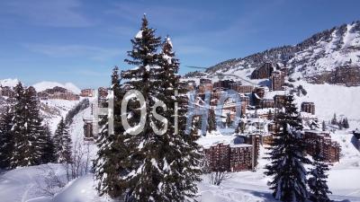 Aerial Shot Of Trees And A Frenc Ski Resort - Video Drone Footage