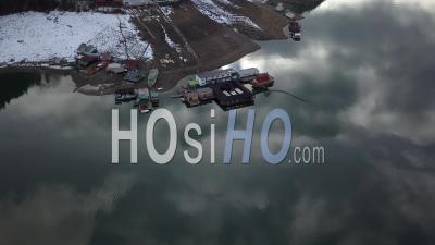 Lake Lacul Rosu And Fishermen Floating Houses By Winter - Video Drone Footage