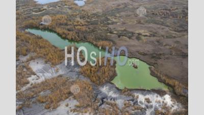 Aerial View Of Autumn Trees And A Lake With Green Water In Abandoned Quarry. - Aerial Photography
