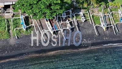 Traditional Fishing Boats On Black Sand Beach In Amed, Bali, Indonesia - Video Drone Footage