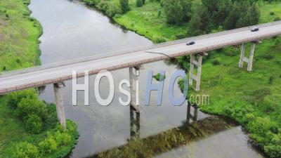 Car Traffic On A Stone Bridge Across A River - Video Drone Footage