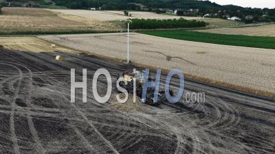 Charred Wreckage Of A Combine Harvester In A Field, France, Drone Point Of View