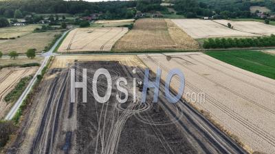Charred Wreckage Of A Combine Harvester In A Field, France, Drone Point Of View